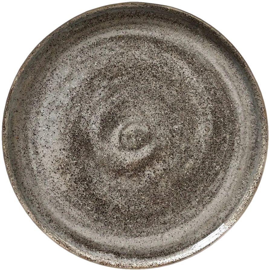 Handmade plate from mixed clay and porcelain with a speckled, stone-like surface and a visible spiral
