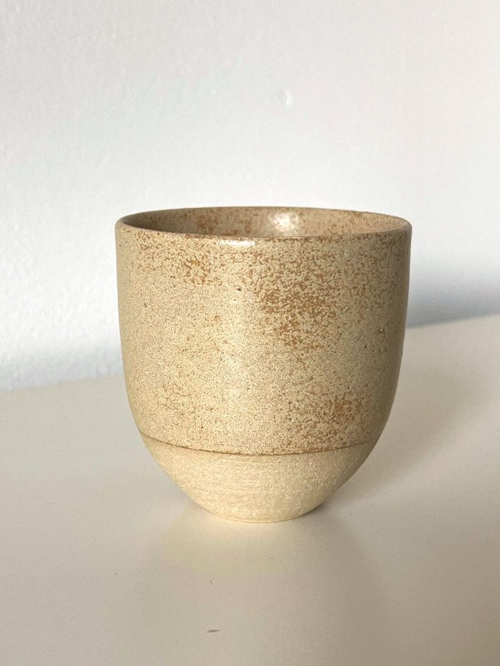 Handmade ceramic cup in a speckled warm sand glaze