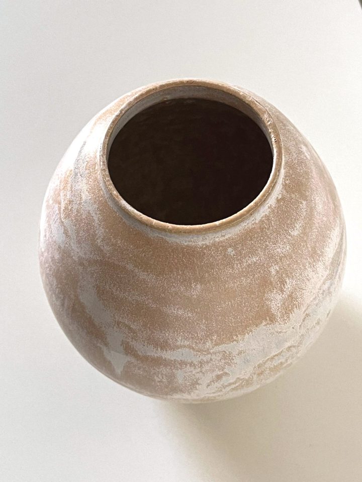 Rounded handmade ceramic vase in warm sand clay with a pale, brushed white glaze, second view