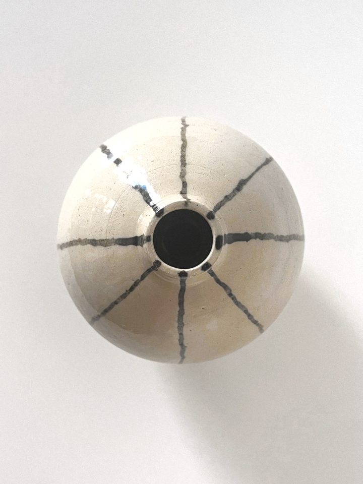 Round cream ceramic vase with a narrow neck and hand-painted dark stripes, second view