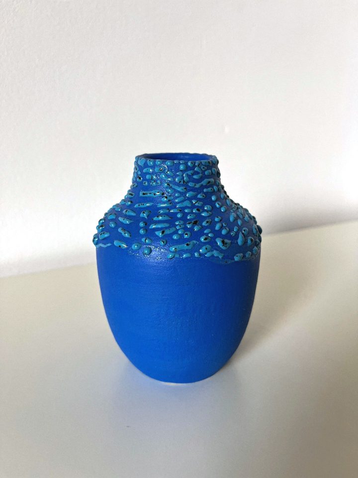 Deep blue handmade ceramic vase with textured droplets around the neck